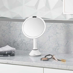 sensor mirror with touch-control brightness and dual light setting - white finish - lifestyle in bedroom image